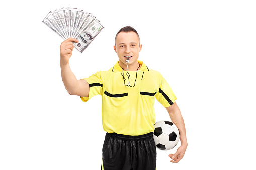 young-male-football-referee-holding-a-stack-of-money