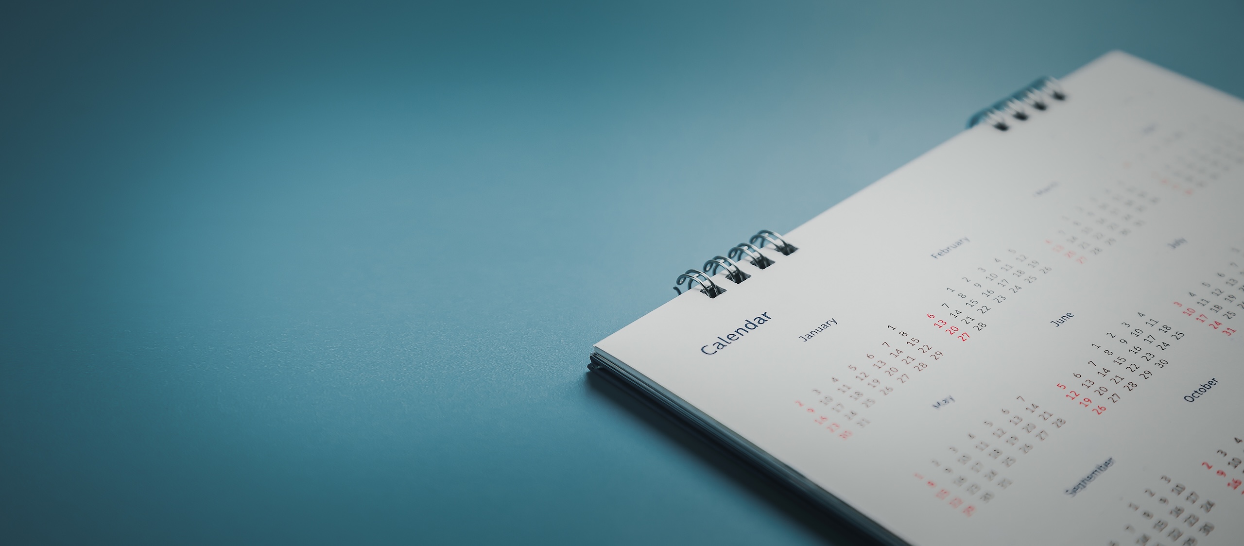 Embroidered red pins on a calendar event Planner calendar,clock to set timetable organize schedule,planning for business meeting or travel planning concept.